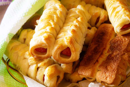 Baked sausages with a golden crust in the dough close-up.の写真素材