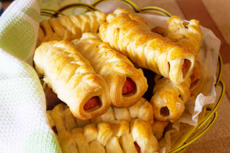 Baked sausages with a golden crust in the dough close-up.の写真素材