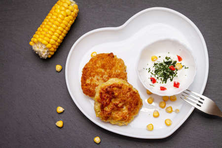 Delicious catlets on a plate with sauce of sour cream and greens close-up.の写真素材
