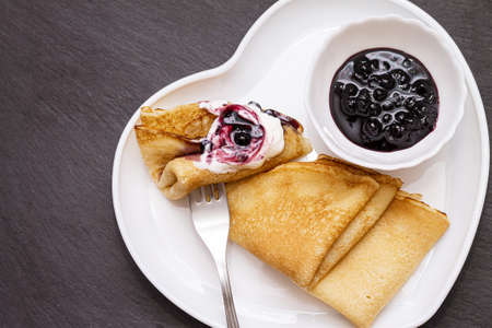 Delicious catlets on a plate with sauce of sour cream and greens close-up.の写真素材