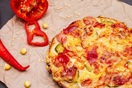 Delicious pizza with sausages, pepper and cheese close-up.の写真素材
