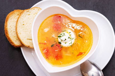 Delicious chicken soup with tomatoes close-up. Dinner.の写真素材