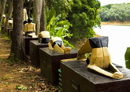 This beautiful sculptures of people making yoga are situated on the lake in Sivananda ashram of Kerala, Indiaの写真素材