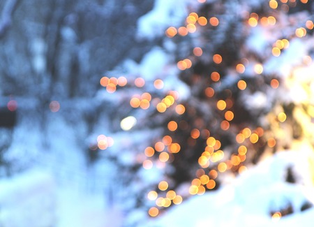 Christmas tree with lights glowing and snowの写真素材