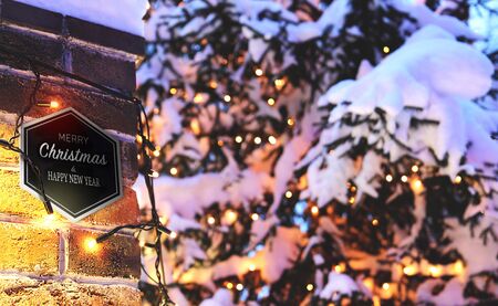 vintage brick wall Christmas background with lights glowing and snow, cardの写真素材