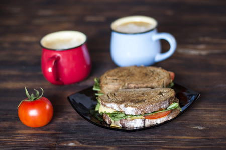 Breakfast, Whole wheat Sandwiches, tomato and coffee for two on wooden tableの写真素材