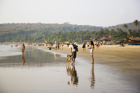 ARAMBOL BEACH, GOA, INDIA - FEBRUARY 15, 2013: People are walking on beach.のeditorial素材