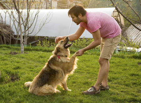 Kazakh man stroking his dog