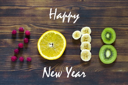 happy new year 2018 of fruit and berries on wooden background.の写真素材