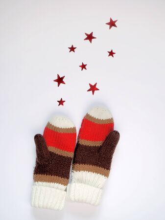 knitted mittens isolated on white background with starsの写真素材