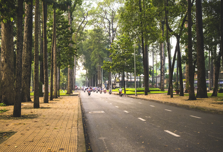 Street of Ho Chi Minh city, Vietnam. People riding bikesの写真素材