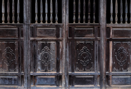 Antique old doors made of wood with ornamentの写真素材
