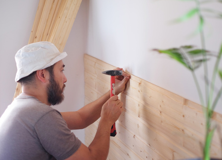 Man building a house and workimg with hammer and woodの写真素材