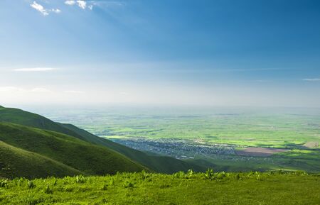 beautiful view from the green hill with a small town downhill.