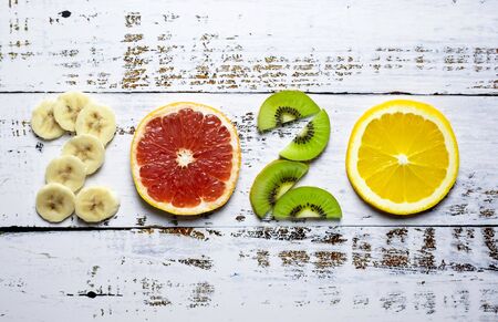 New year 2020 made of fruit on white wooden background.