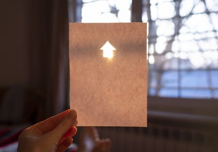 White sheet of paper with a shiny house sign and copy spaceの写真素材