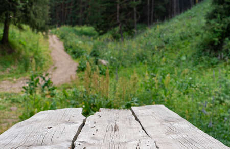 Empty old wooden table outdoor in summer with beautiful nature in backgroundの写真素材