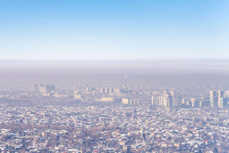 View of Almaty city and smog over it. Almaty, Kazakhstan.