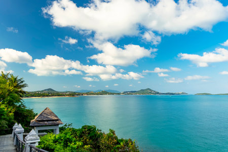 Beautiful view from the hill to Koh Samui. Triangular roof, turquoise sea and green mountainsの写真素材
