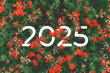 2025 New year white text hidden in red flowers and green leaves.の写真素材
