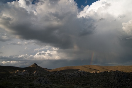 Rainbow and Clouds in a horizontal orientation over the eastern sierras and mono lakeの写真素材