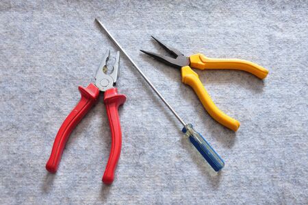 Two pliers and screwdriver