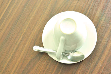 Coffee cup with spoon on wooden background 