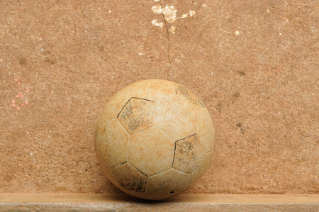 Old football on grunge cement floorの写真素材