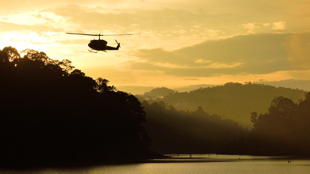 Silhouette helicopter and forest landscape at Bang Lang National Park, Thailandの写真素材