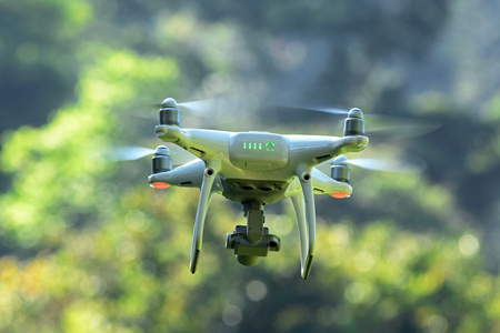 Drone hovering on green nature bokeh backgroundの写真素材