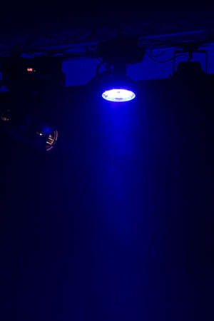 An empty stage of the theater, lit by spotlights and smoke before the performance