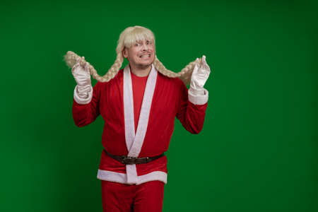 Emotional Santa Claus with long braid hairstyle grimaces and poses on a green chrome background