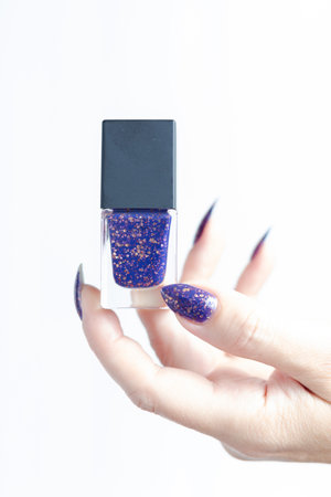 Female hands with long nails with purple nail polish
