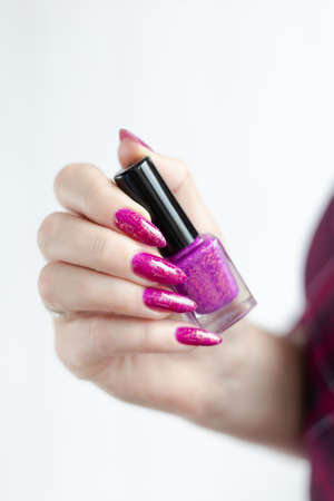 Woman hands with long nails with pink magenta nail polish