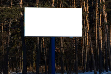 Background for design. Advertising billboard along the road in the city on a winter sunny dayの写真素材