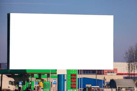 Billboard along the road and highway on a winter snow day. Background for design and advertising.