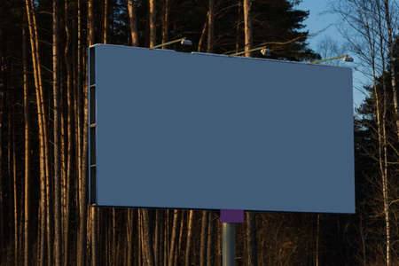 Background for design. Advertising billboard along the road in the city on a winter sunny day
