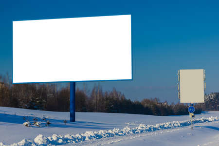 Background for design. Advertising billboard along the road in the city on a winter sunny dayの写真素材