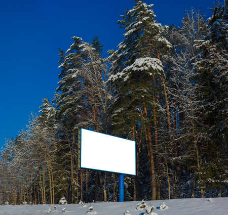 Background for design. Advertising billboard along the road in the city on a winter sunny dayの写真素材