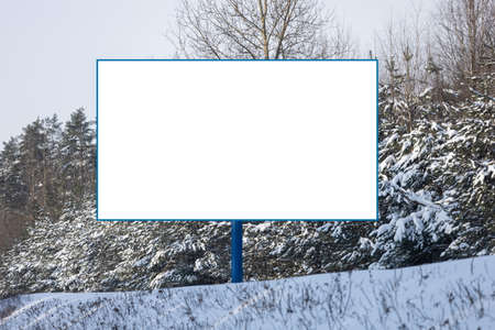 Background for design. Advertising billboard along the road in the city on a winter sunny day