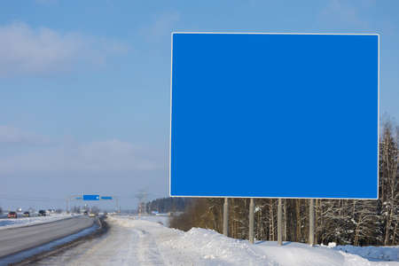 Billboard along the road and highway on a winter snow day. Background for design and advertising.の写真素材