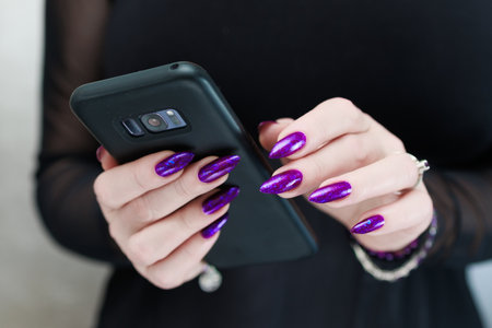 Woman's hands holding a smartphoneの写真素材