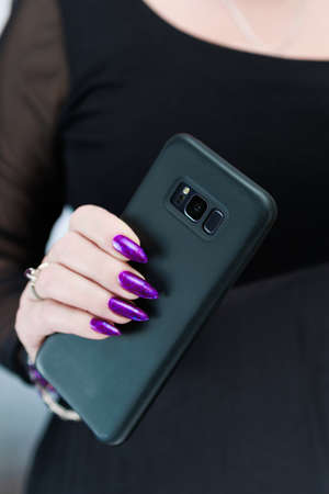 Woman's hands holding a smartphone