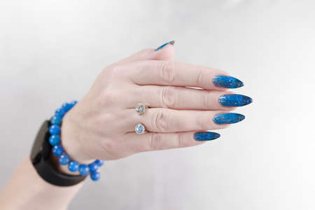 Female hands with long nails with bright blue nail polish