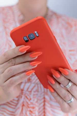 Woman's hands holding a large black smartphone