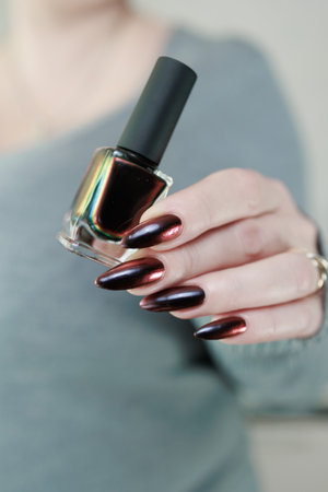 Female hands with long nails and black and red nail polishの写真素材