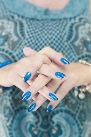 Woman's beautiful hand with long nails and light blue manicureの写真素材