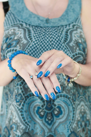 Woman's beautiful hand with long nails and light blue manicureの写真素材