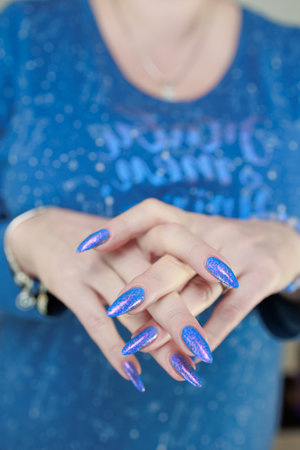 Female hand with long nails, pink and light blue manicureの写真素材