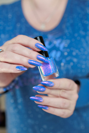 Female hand with long nails, pink and light blue manicureの写真素材